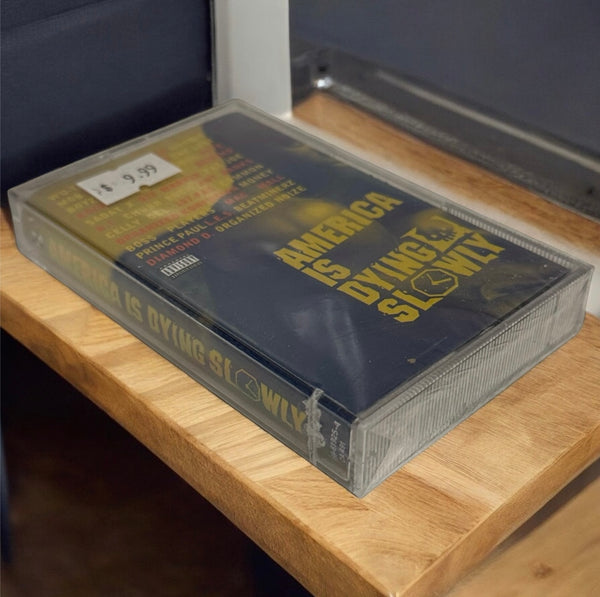 •AMERICA IS DYING SLOWLY - COMPILATION• ~1996 SEALED/SPINE CUT CASSETTE TAPE~ (EUROPE RELEASE)